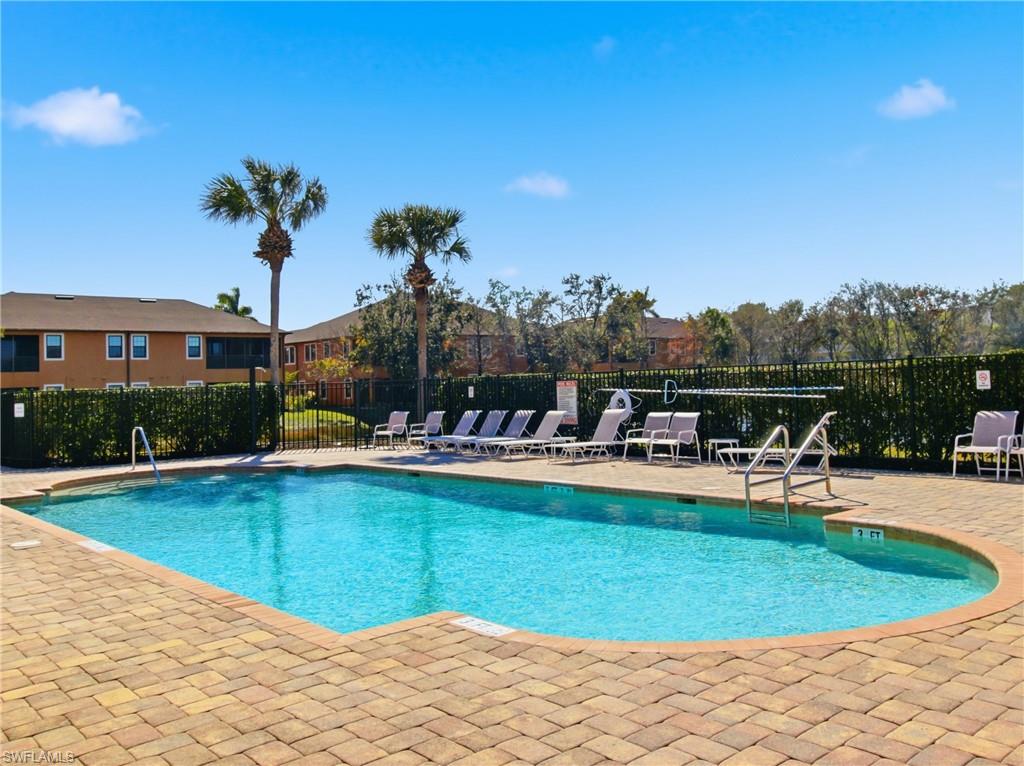 20161 Bravada Street, Unit 2 Estero, FL 33928 - Photo 29 of 33 a view of a swimming pool with a table and chairs
