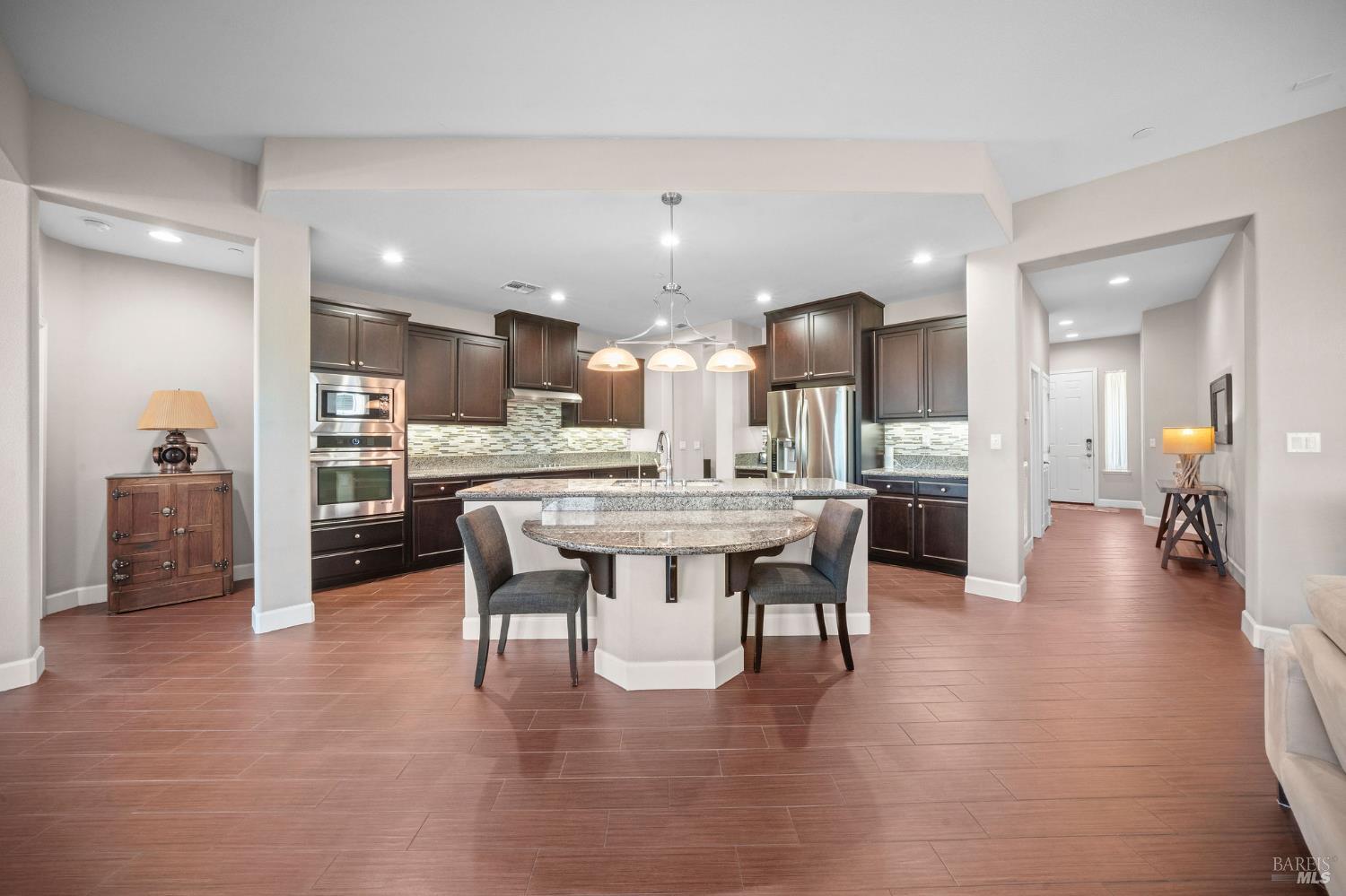 316 Birch Ridge Drive Rio Vista, CA 94571 - Photo 8 of 70 a dining hall with stainless steel appliances kitchen island granite countertop a dining table chairs and view kitchen