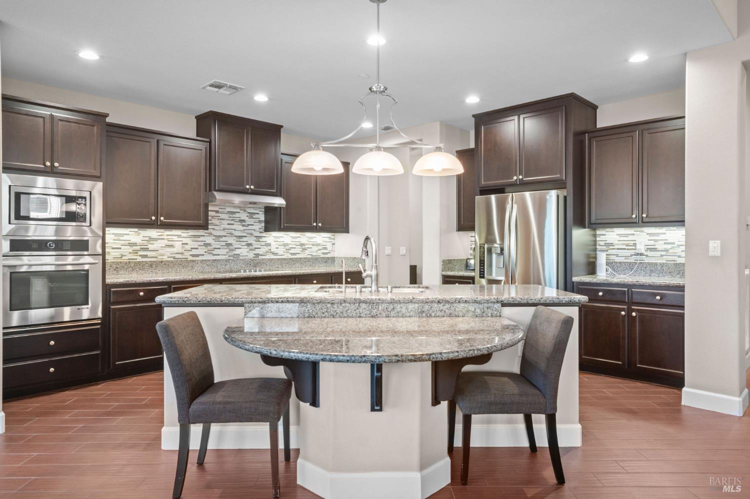 316 Birch Ridge Drive Rio Vista, CA 94571 - Photo 10 of 70 a kitchen with stainless steel appliances granite countertop a kitchen island and chairs in it