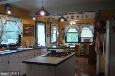 60 East Nicodemus Road Westminster, MD 21157 - Photo 5 of 21 a kitchen with sink stove and cabinets