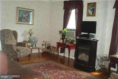 60 East Nicodemus Road Westminster, MD 21157 - Photo 6 of 21 a living room with furniture a dining table and a fireplace