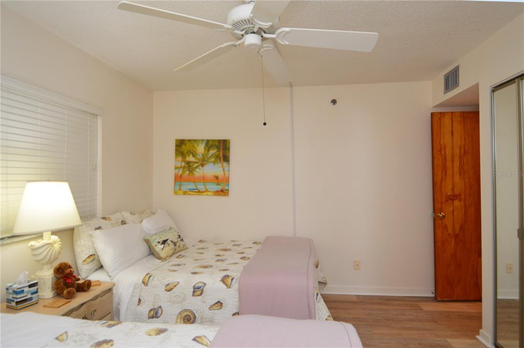 900 Gulf Boulevard, Unit 907 Indian Rocks Beach, FL 33785 - Photo 52 of 88 a bedroom with a bed and a lamp