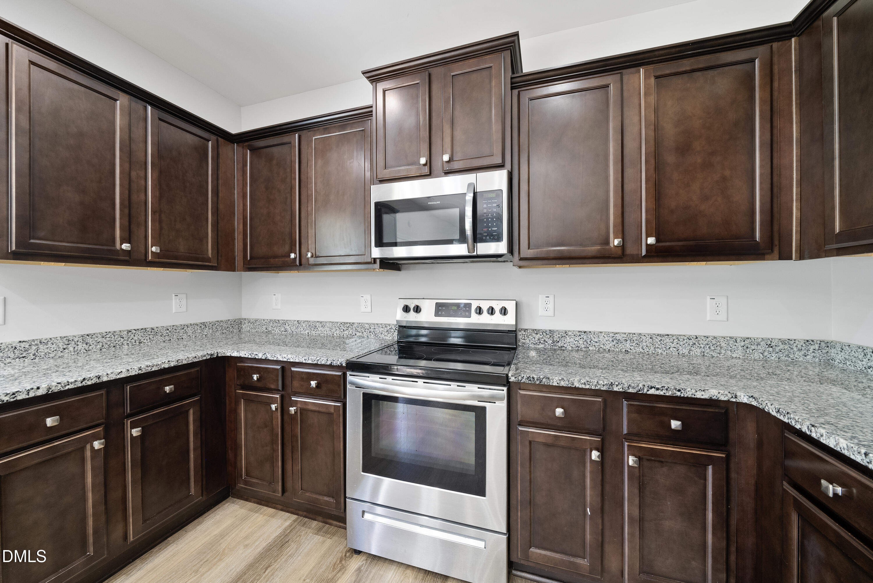 2816 Elsa Drive Raleigh, NC 27610 - Photo 19 of 35 a kitchen with granite countertop wood cabinets and stainless steel appliances