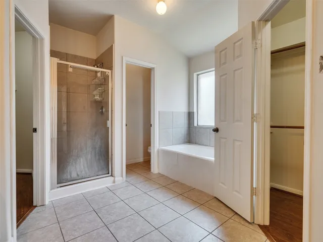 a view of a bathroom with bathtub and shower