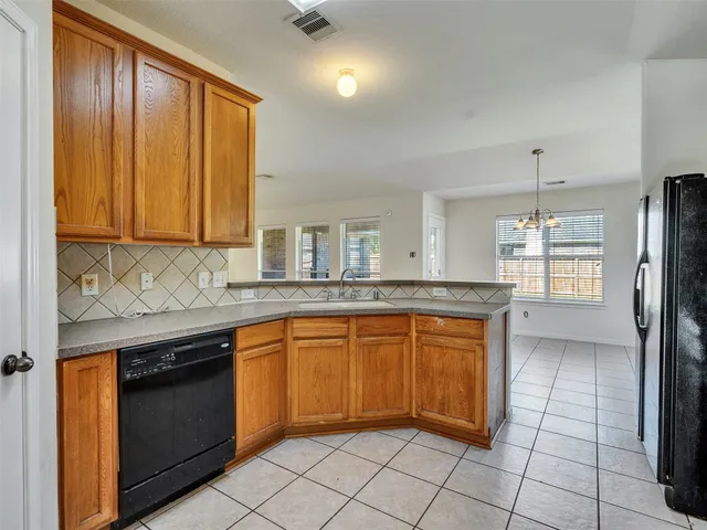 a kitchen with stainless steel appliances granite countertop a refrigerator a stove and a sink with cabinets