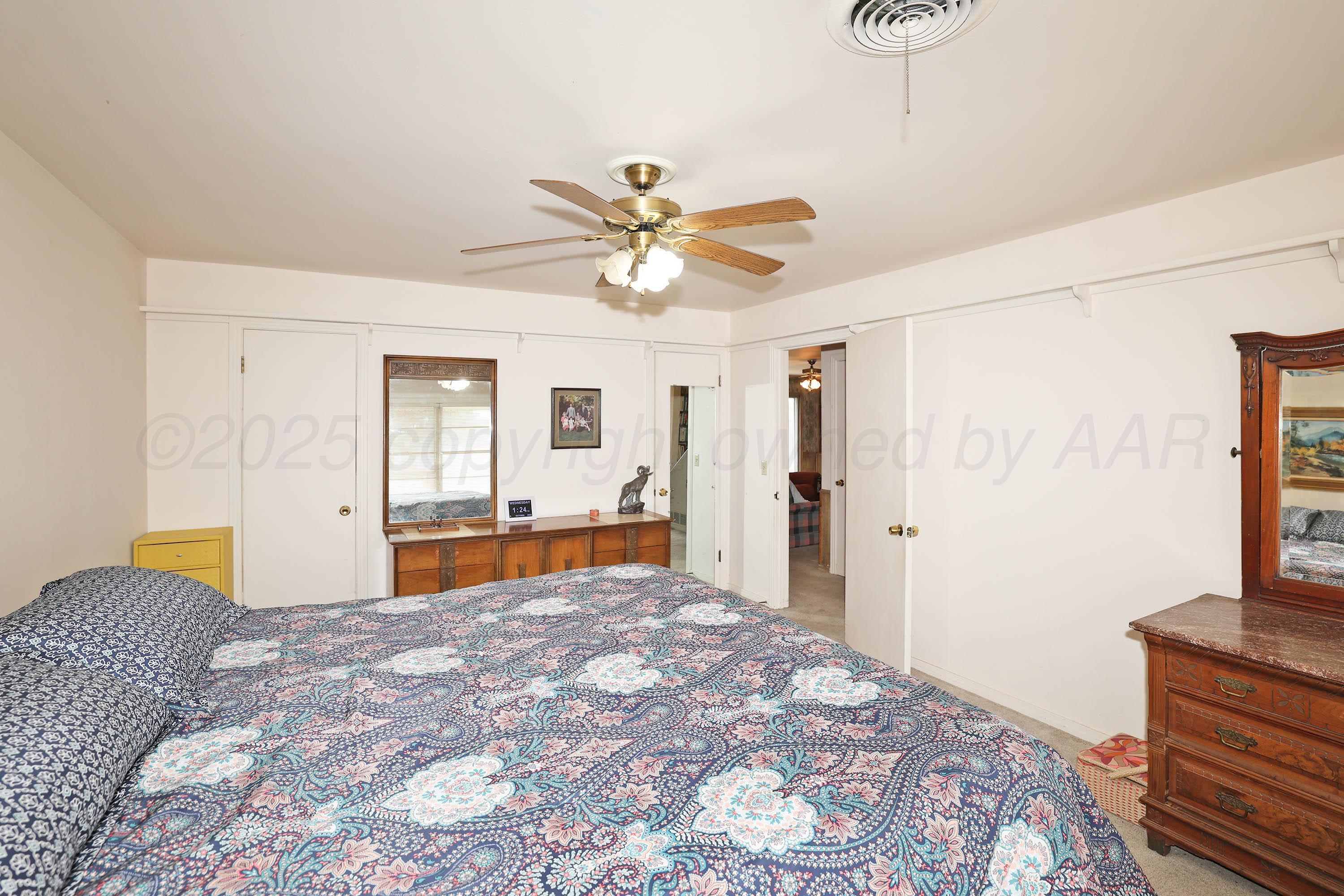 2816 Lloyd Drive Amarillo, TX 79110 - Photo 16 of 29 a bedroom with a bed and a chandelier