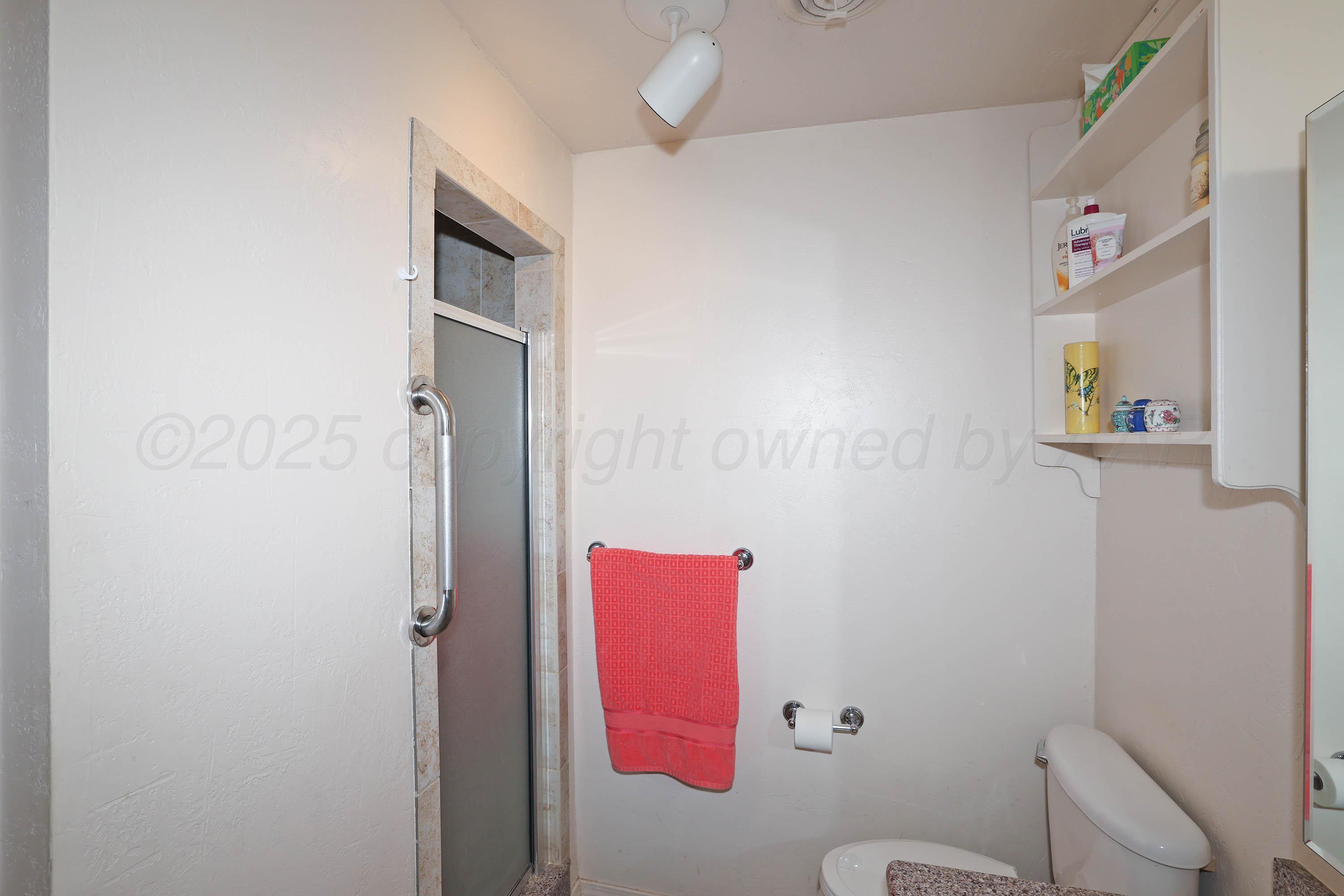2816 Lloyd Drive Amarillo, TX 79110 - Photo 19 of 29 a bathroom with a toilet and a shower