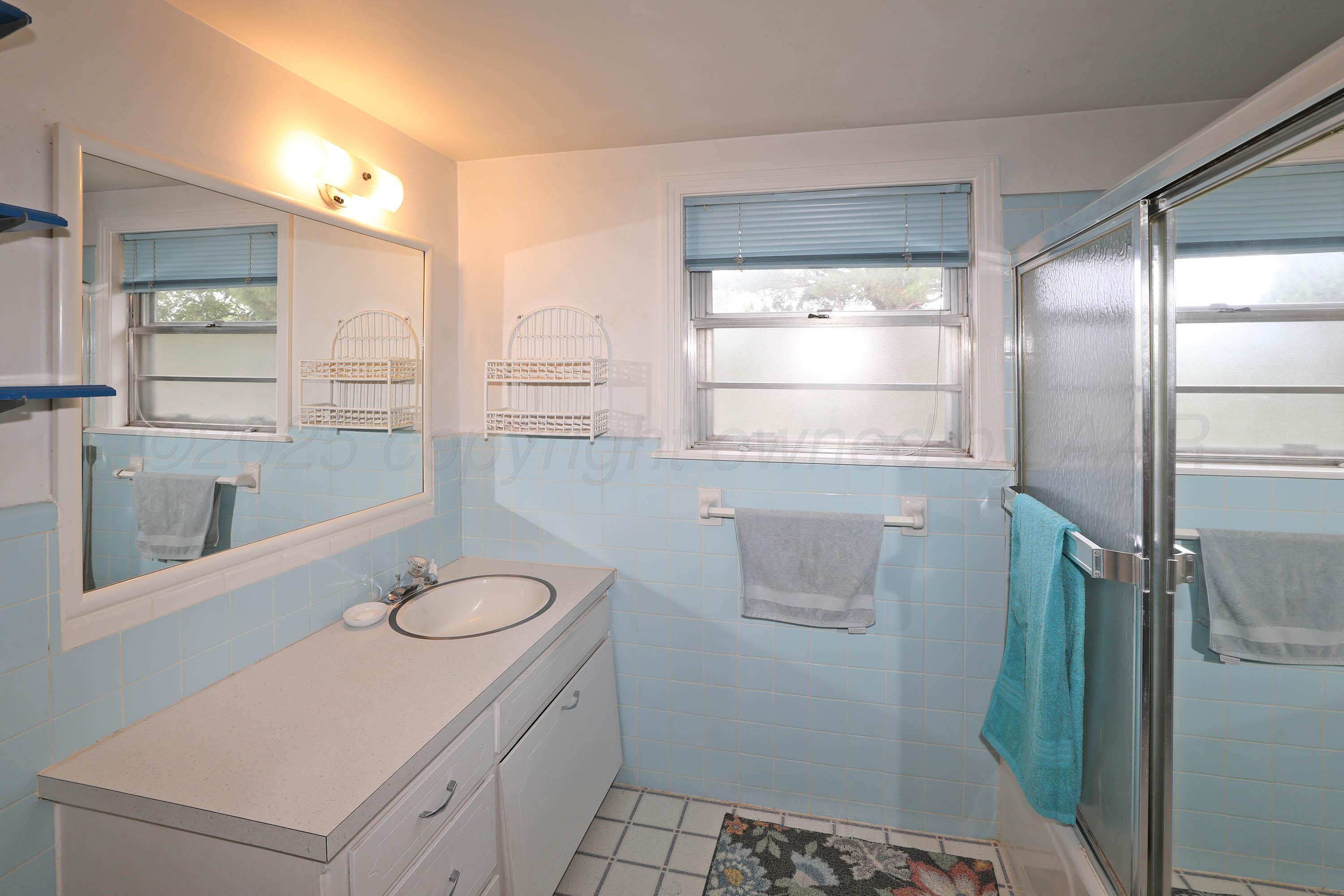 2816 Lloyd Drive Amarillo, TX 79110 - Photo 26 of 29 a bathroom with a sink and a mirror