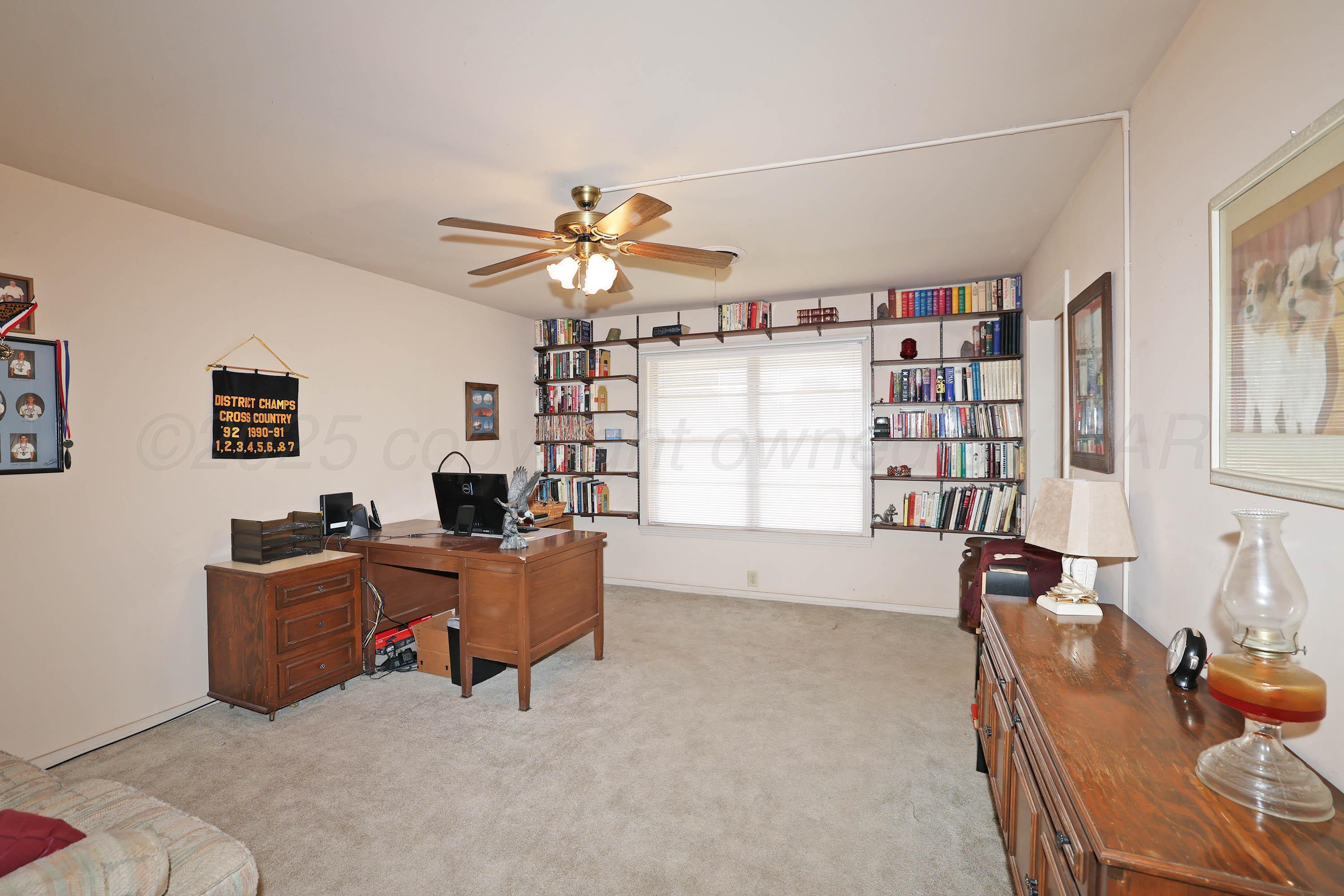 2816 Lloyd Drive Amarillo, TX 79110 - Photo 5 of 29 a living room with furniture and a book shelf