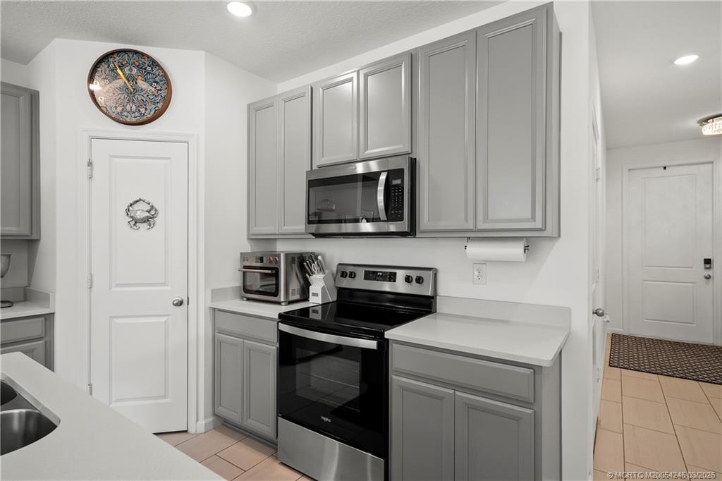380 Southeast Sea Hunt Way Stuart, FL 34994 - Photo 11 of 42 a kitchen with a stove and a microwave