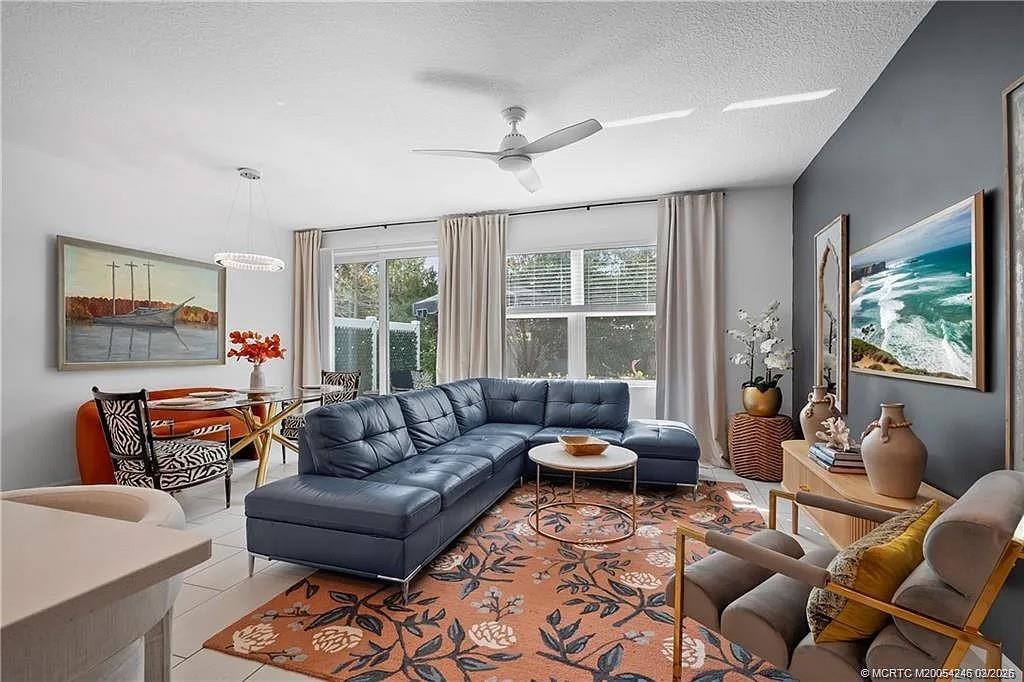 380 Southeast Sea Hunt Way Stuart, FL 34994 - Photo 13 of 42 a living room with furniture a flat screen tv and a large window