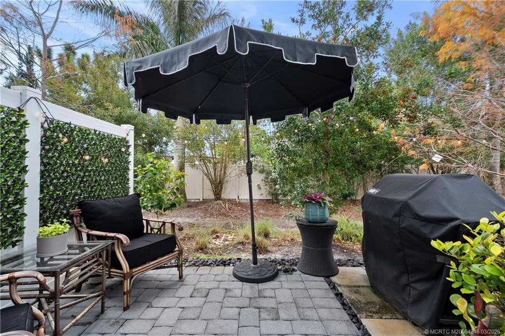 380 Southeast Sea Hunt Way Stuart, FL 34994 - Photo 19 of 42 a patio with table and chairs