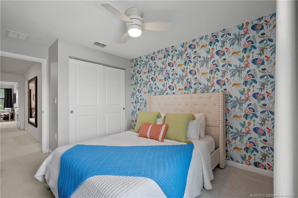 380 Southeast Sea Hunt Way Stuart, FL 34994 - Photo 22 of 42 a bedroom with a bed and a painting on the wall