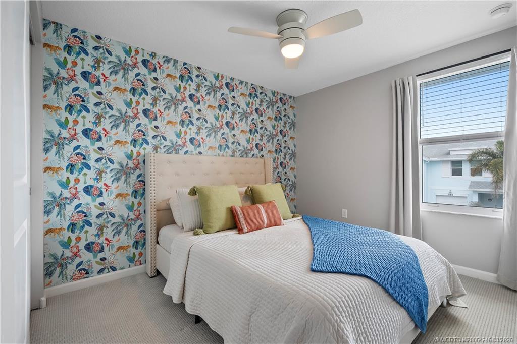 380 Southeast Sea Hunt Way Stuart, FL 34994 - Photo 23 of 42 a bedroom with a bed and a painting on the wall