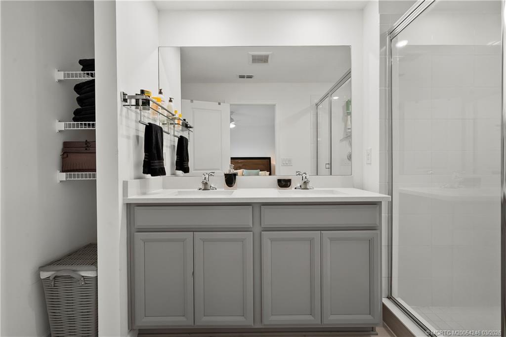 380 Southeast Sea Hunt Way Stuart, FL 34994 - Photo 28 of 42 a bathroom with a sink and a mirror