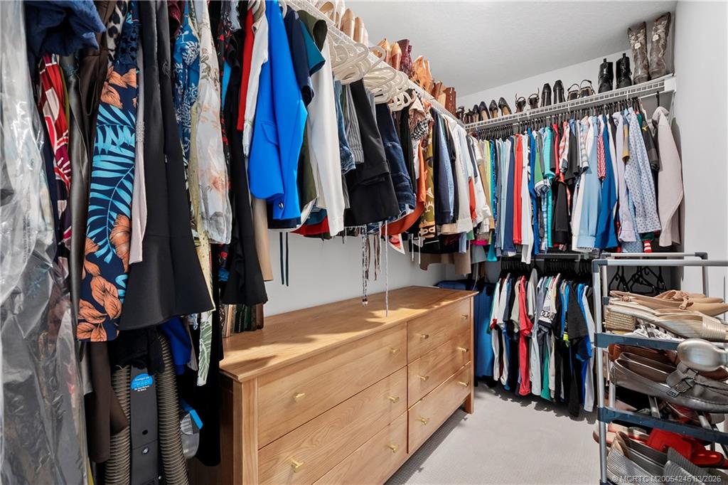 380 Southeast Sea Hunt Way Stuart, FL 34994 - Photo 30 of 42 a view of walk in closet with clothes and shoes