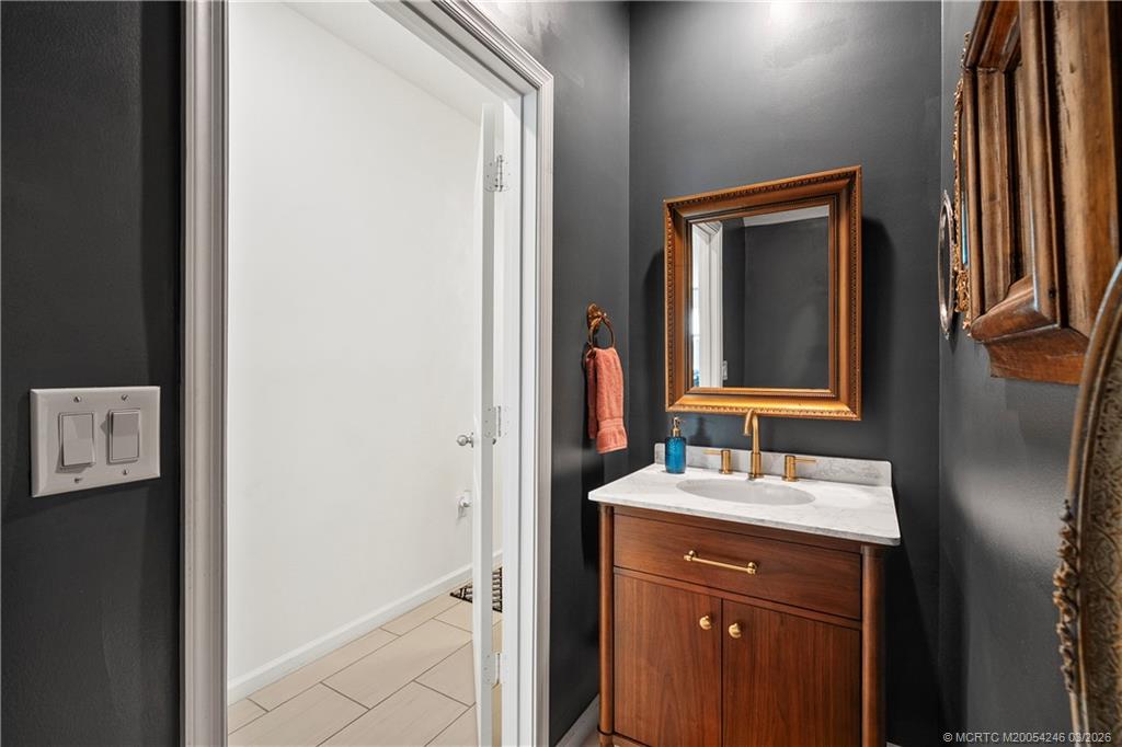 380 Southeast Sea Hunt Way Stuart, FL 34994 - Photo 6 of 42 a bathroom with a sink and a mirror