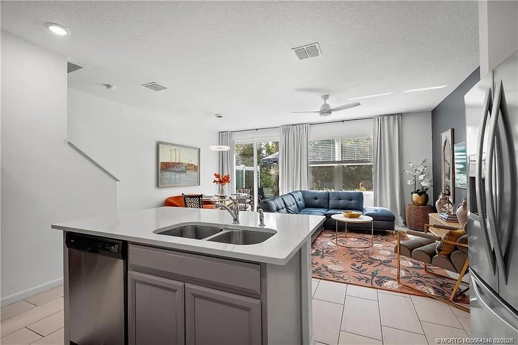 380 Southeast Sea Hunt Way Stuart, FL 34994 - Photo 10 of 42 a kitchen with a sink and cabinets