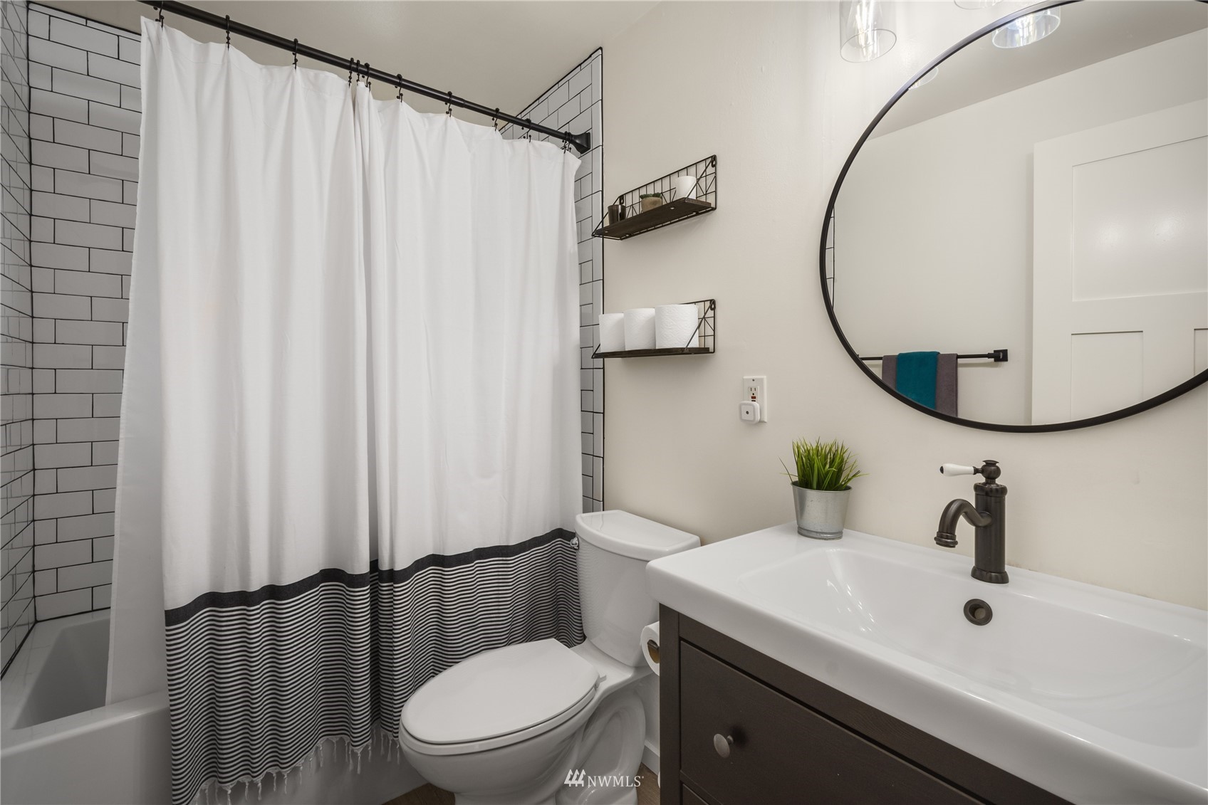 831 Pine Street Edmonds, WA 98020 - Photo 16 of 35 a bathroom with a sink a toilet and a mirror