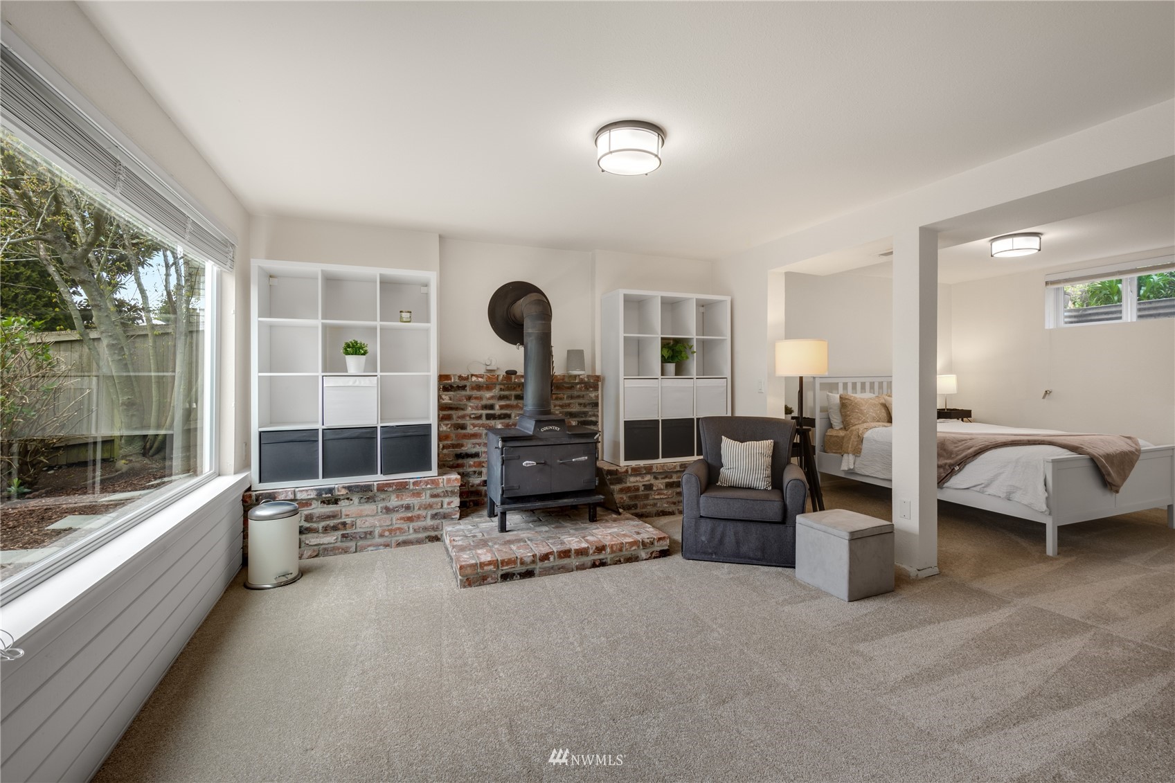 831 Pine Street Edmonds, WA 98020 - Photo 21 of 35 a living room with furniture a large window and gym equipment