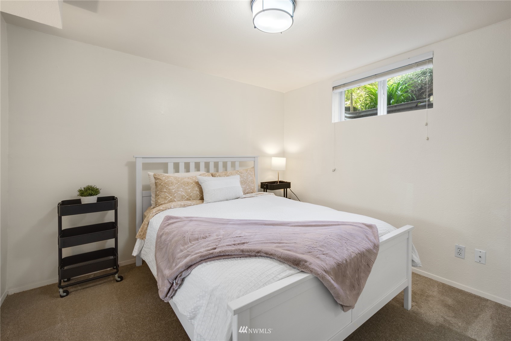 831 Pine Street Edmonds, WA 98020 - Photo 23 of 35 a spacious bedroom with a bed and a window