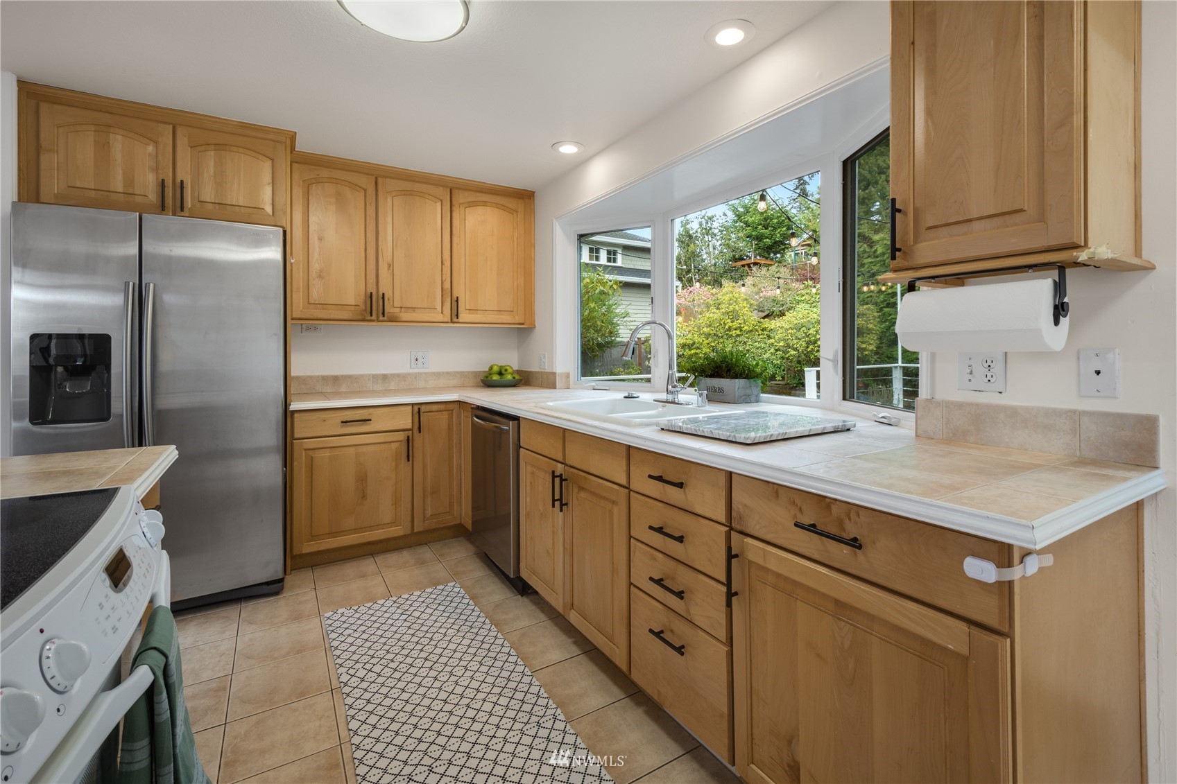 831 Pine Street Edmonds, WA 98020 - Photo 3 of 35 a kitchen with sink cabinets and window