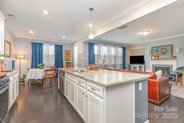 a kitchen with stainless steel appliances granite countertop sink stove and refrigerator