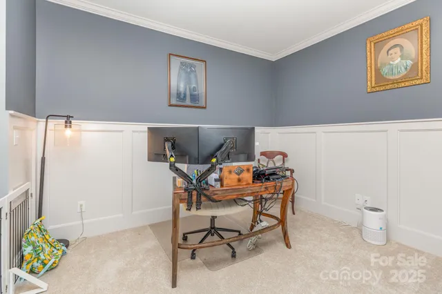 a work room with furniture and a potted plant