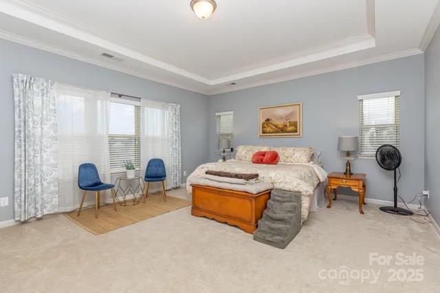 a bedroom with a bed and a large window