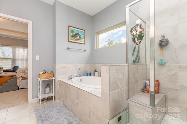 a bathroom with a tub sink and mirror