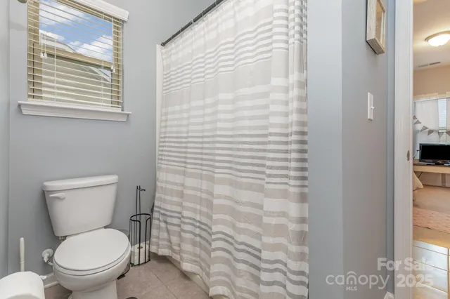 a white toilet sitting next to a bathroom sink