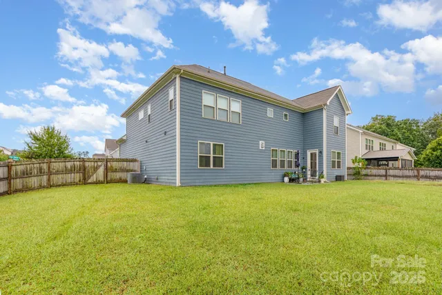 a backyard of a house with table and chairs