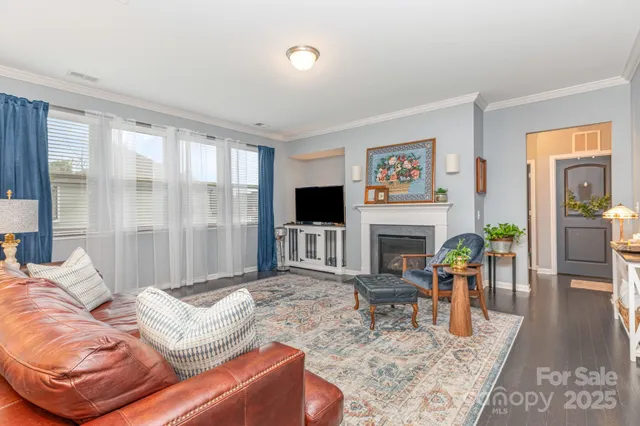 a living room with furniture fireplace and a flat screen tv