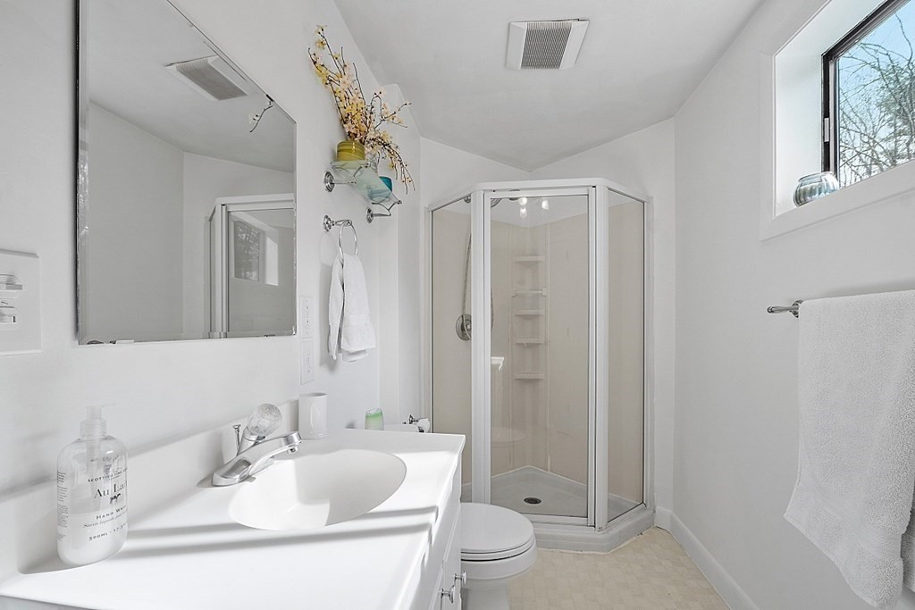 10 Orch Hl Road Harvard, MA 01451 - Photo 22 of 33 a bathroom with a sink a toilet a mirror a vanity and shower