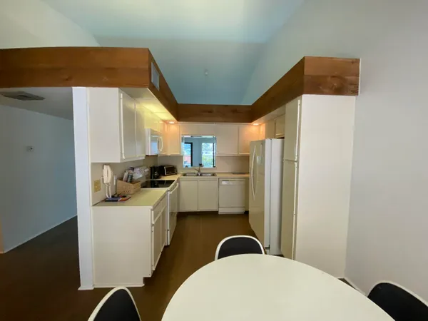 a kitchen with a sink a refrigerator and cabinets