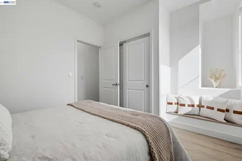 a bedroom with a bed and a mirror