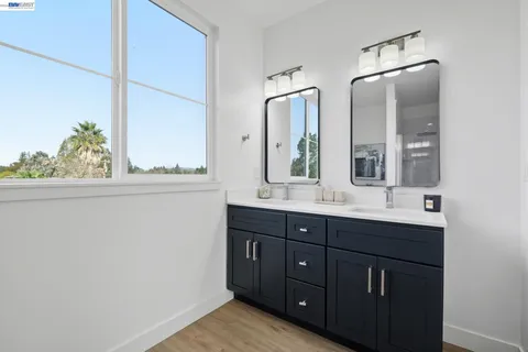 a bathroom with a double vanity sink and mirror