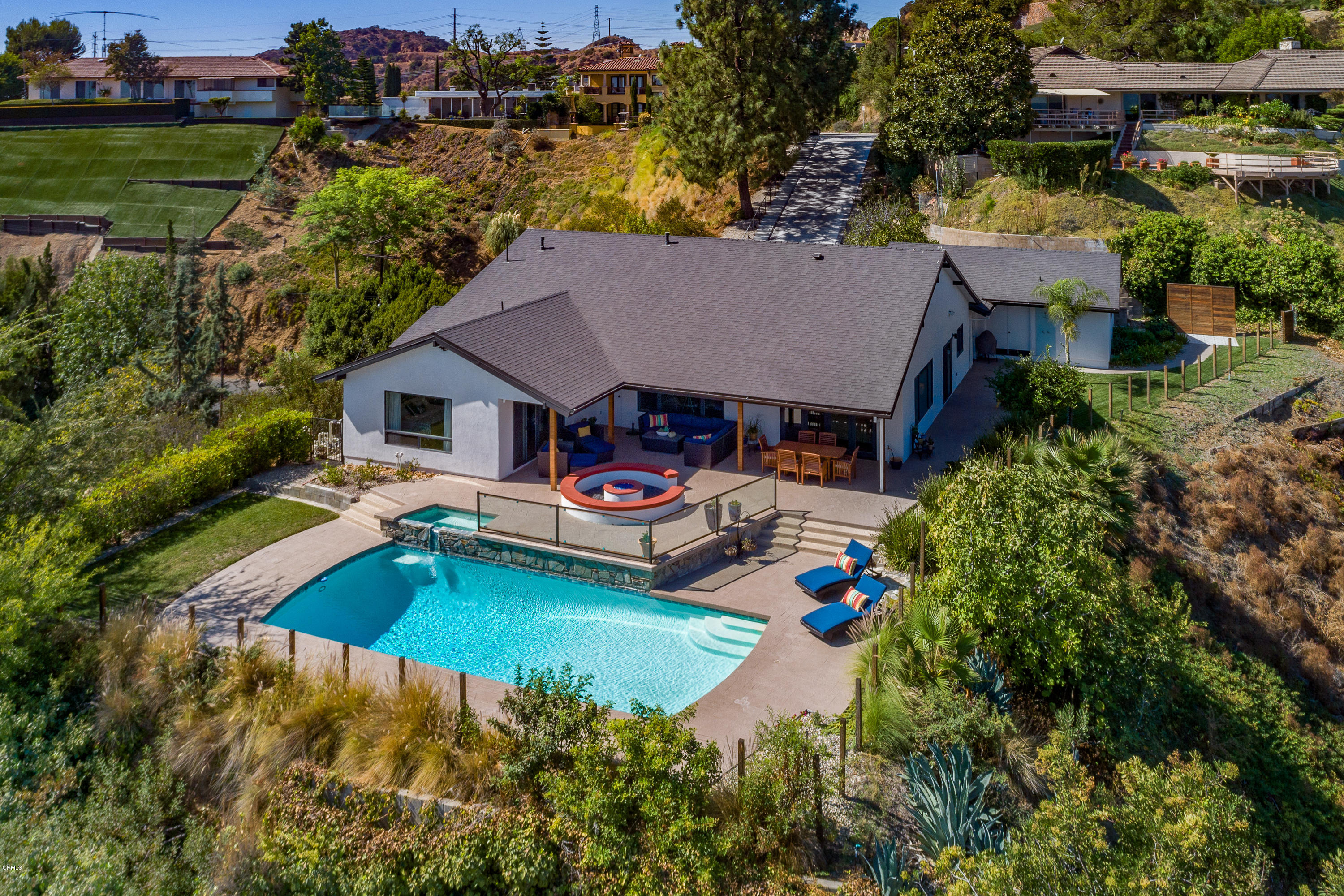 an aerial view of a house with swimming pool patio and lake view
