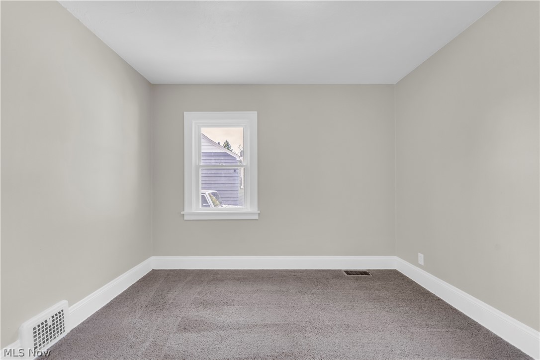 18123 McCracken Road Maple Heights, OH 44137 - Photo 16 of 27 Room featuring neutral wall paint, white trim, a single window, and carpet flooring
