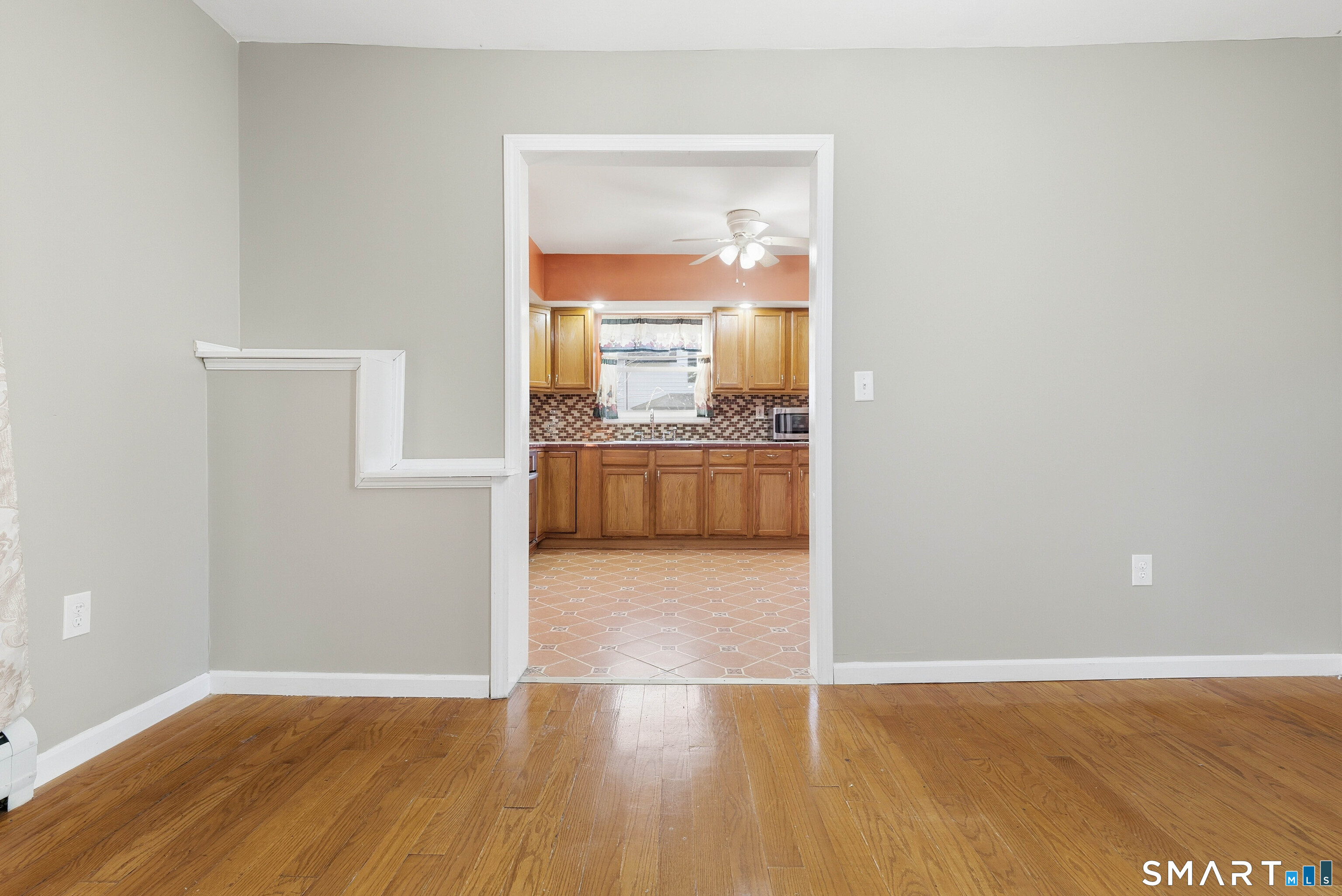 10 Russell Road Norwich, CT 06360 - Photo 13 of 33 an empty room with wooden floor and a door