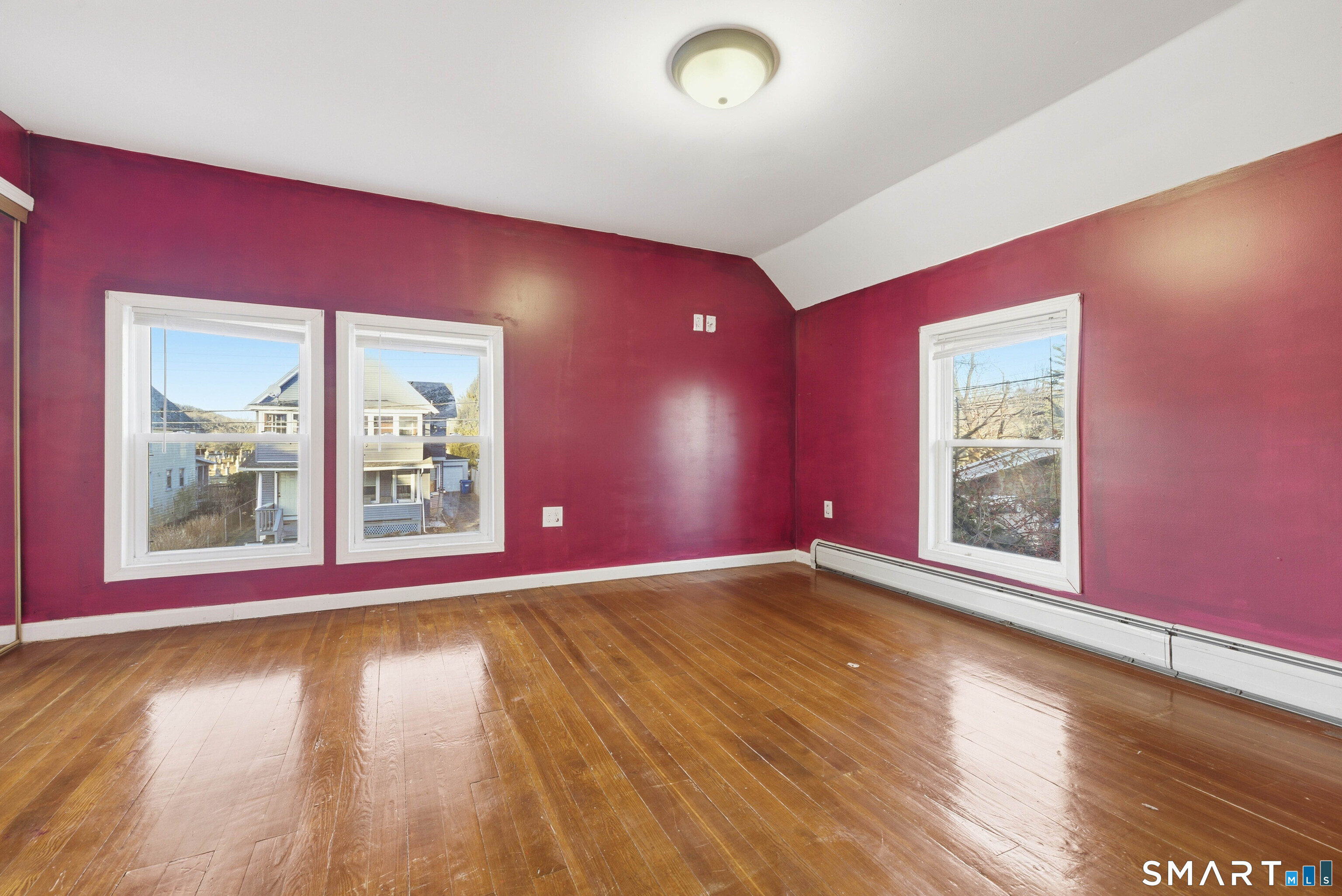 10 Russell Road Norwich, CT 06360 - Photo 22 of 33 a view of an empty room with wooden floor and a window
