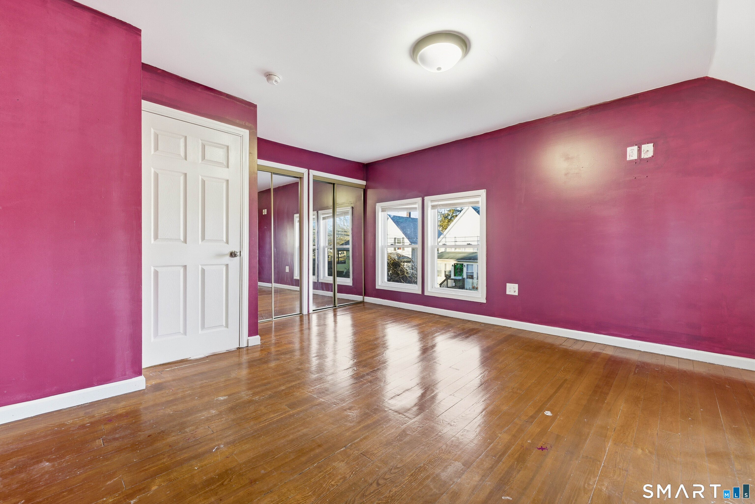 10 Russell Road Norwich, CT 06360 - Photo 24 of 33 an empty room with wooden floor and windows