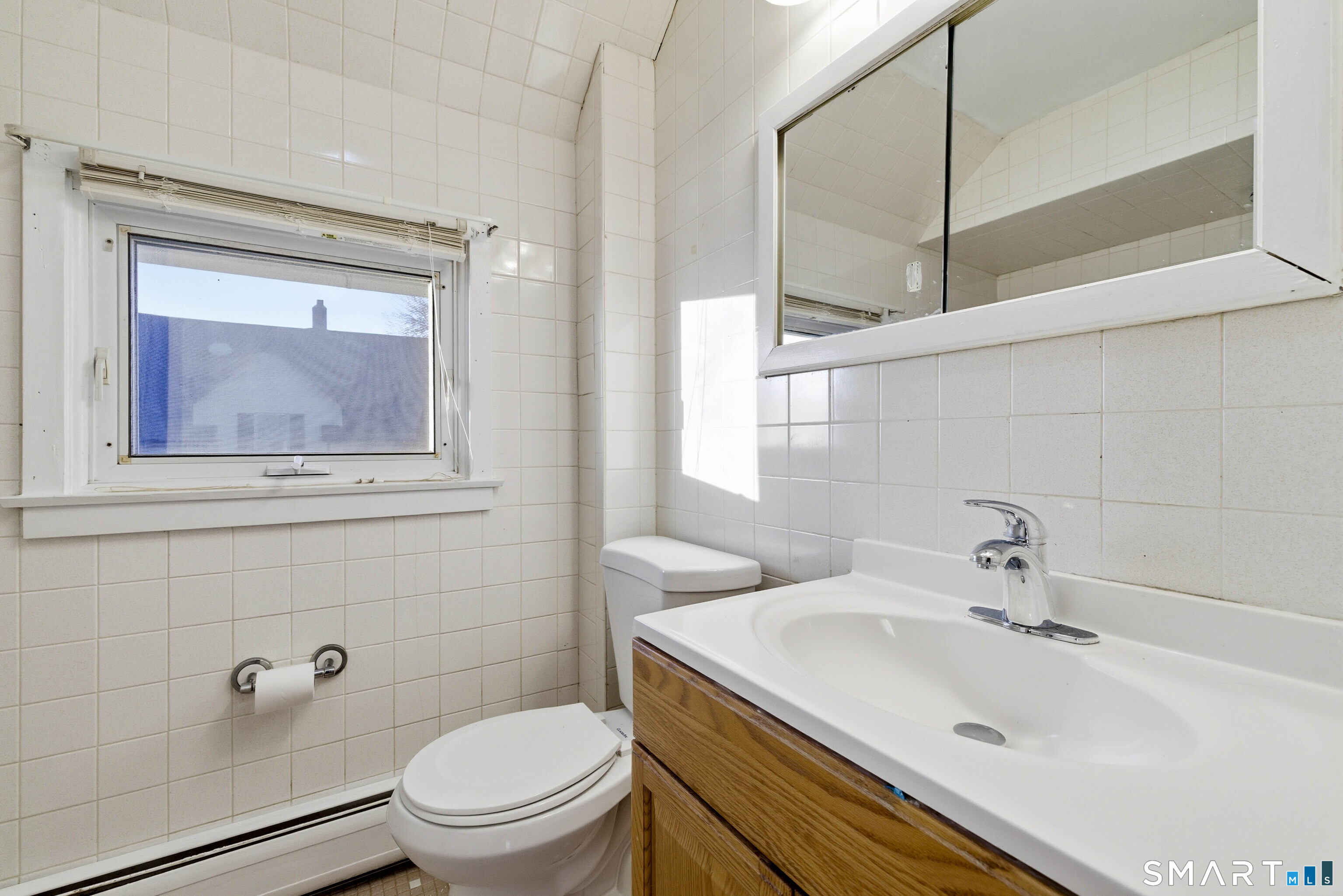 10 Russell Road Norwich, CT 06360 - Photo 27 of 33 a bathroom with a sink a toilet and a mirror