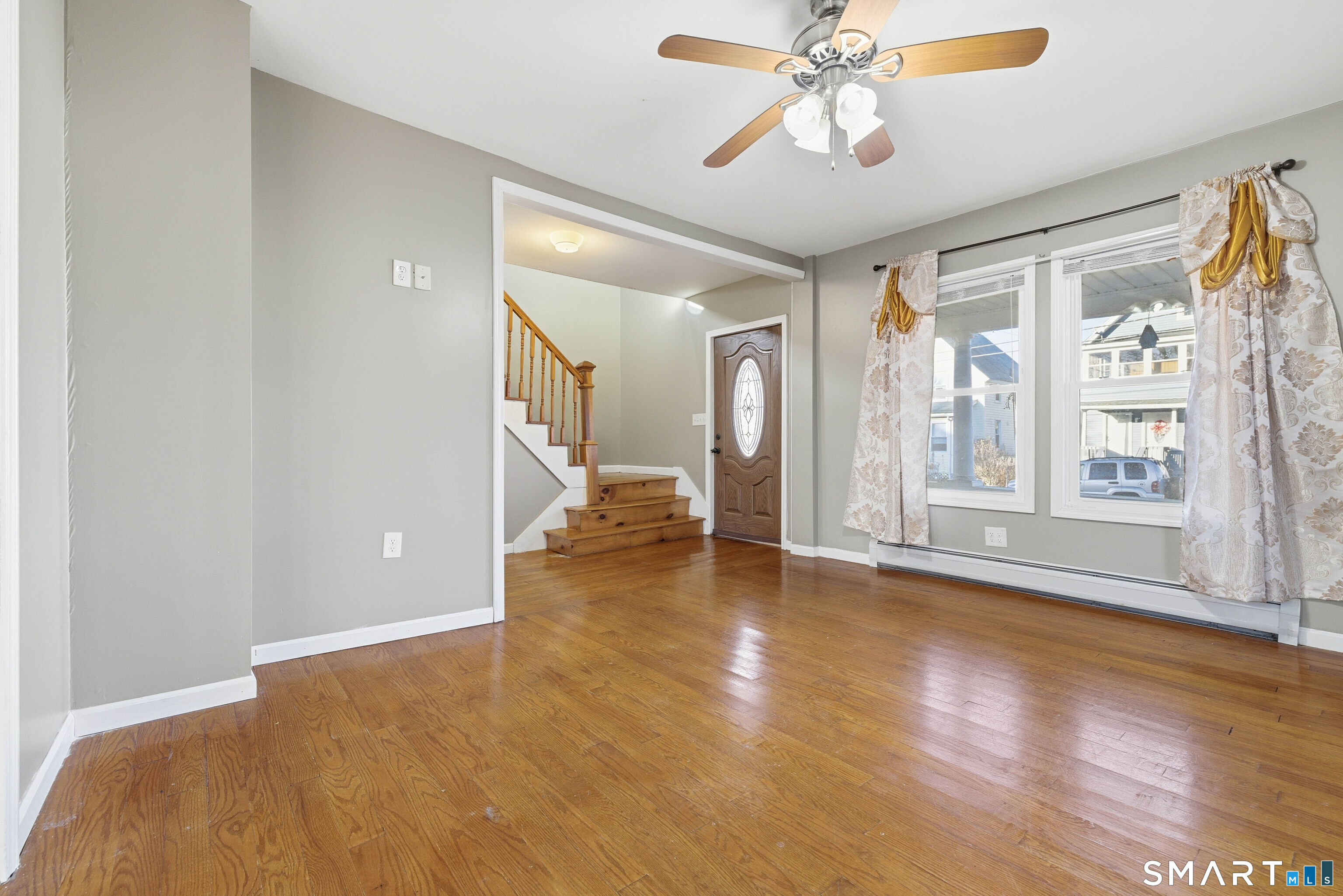 10 Russell Road Norwich, CT 06360 - Photo 7 of 33 a view of an empty room with window and wooden floor