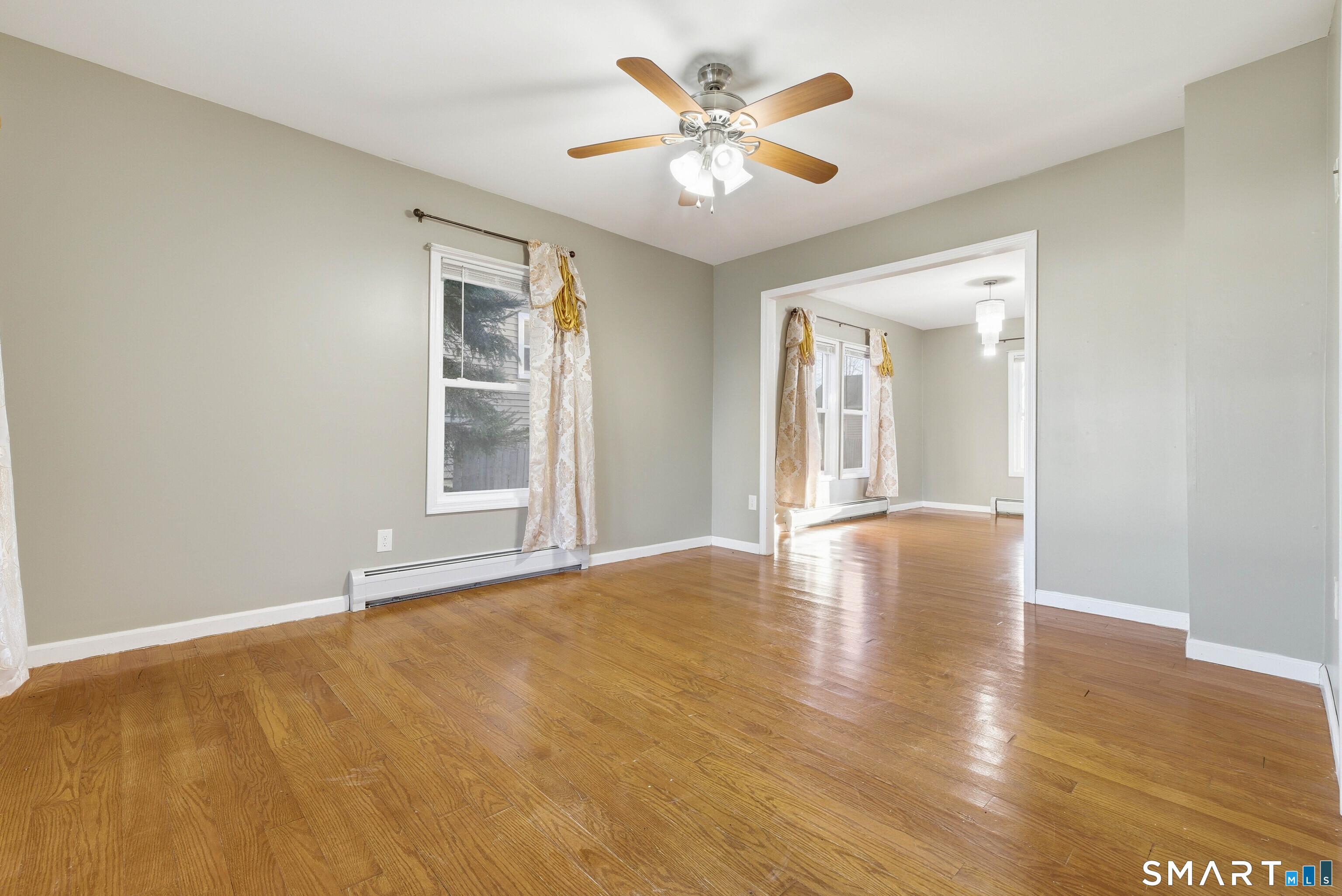 10 Russell Road Norwich, CT 06360 - Photo 8 of 33 a view of an empty room with window and wooden floor