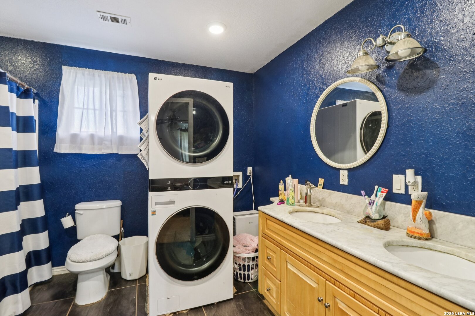 215-213 Coughran Road Pleasanton, TX 78064 - Photo 6 of 13 a bathroom with a toilet a sink and a mirror