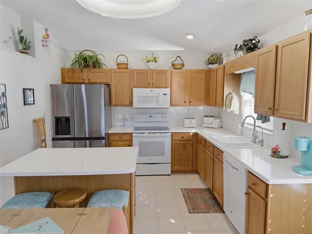 a kitchen with stainless steel appliances a stove a sink and a refrigerator