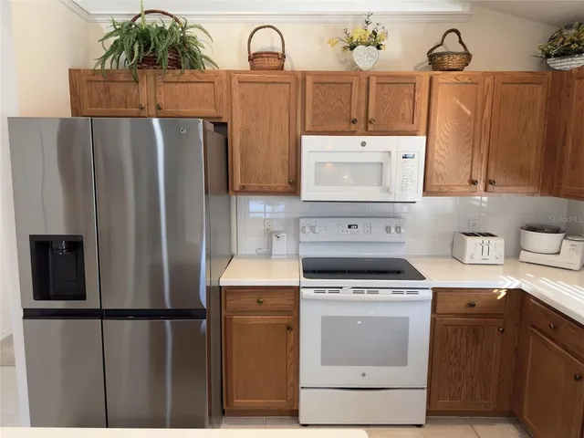 a kitchen with a stove a refrigerator and a sink