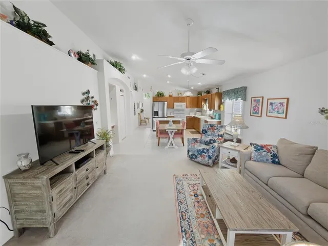 a view of a livingroom with workspace and a window