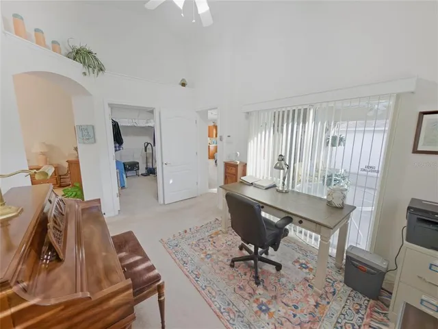 a bedroom with a bed and a potted plant